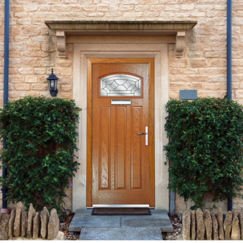 Oak wood-grain effect composite front door on a natural stone property