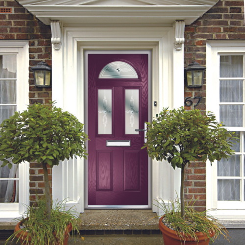 Bold purple composite front door with a white frame on a traditional brick home