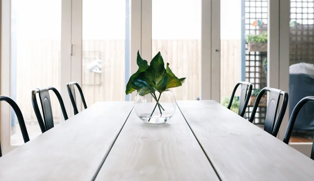 Well-lit Dining area with white aluminium Bi Fold Doors in Blandford