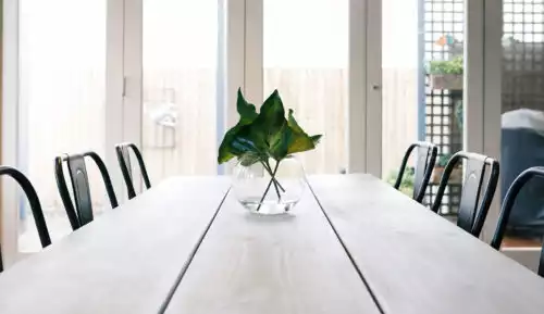 Well-lit Dining area with white aluminium Bi Fold Doors in Blandford