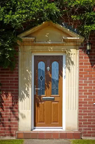 bespoke timber alternative upvc door with woodgrain effect white door frame and decorative glazing